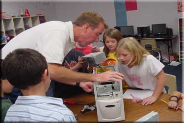 Photo of Computer Expert Parent and Children Exploring Inside of Computer